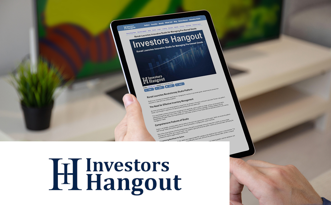 The image shows a tablet device being held in someone's hands, displaying an article titled "Ronati Launches Innovative Studio for Managing Pre-Owned Goods" on what appears to be the Investors Hangout website. The tablet screen shows the beginning of the article with headings including "The Need for Effective Inventory Management" and "Comprehensive Features of Studio" visible. At the bottom of the image is the Investors Hangout logo, featuring "IH" in navy blue beside the words "Investors Hangout" in matching typography. The background shows a blurred desk setting with what appears to be a plant and possibly a monitor, creating a modern workspace atmosphere.