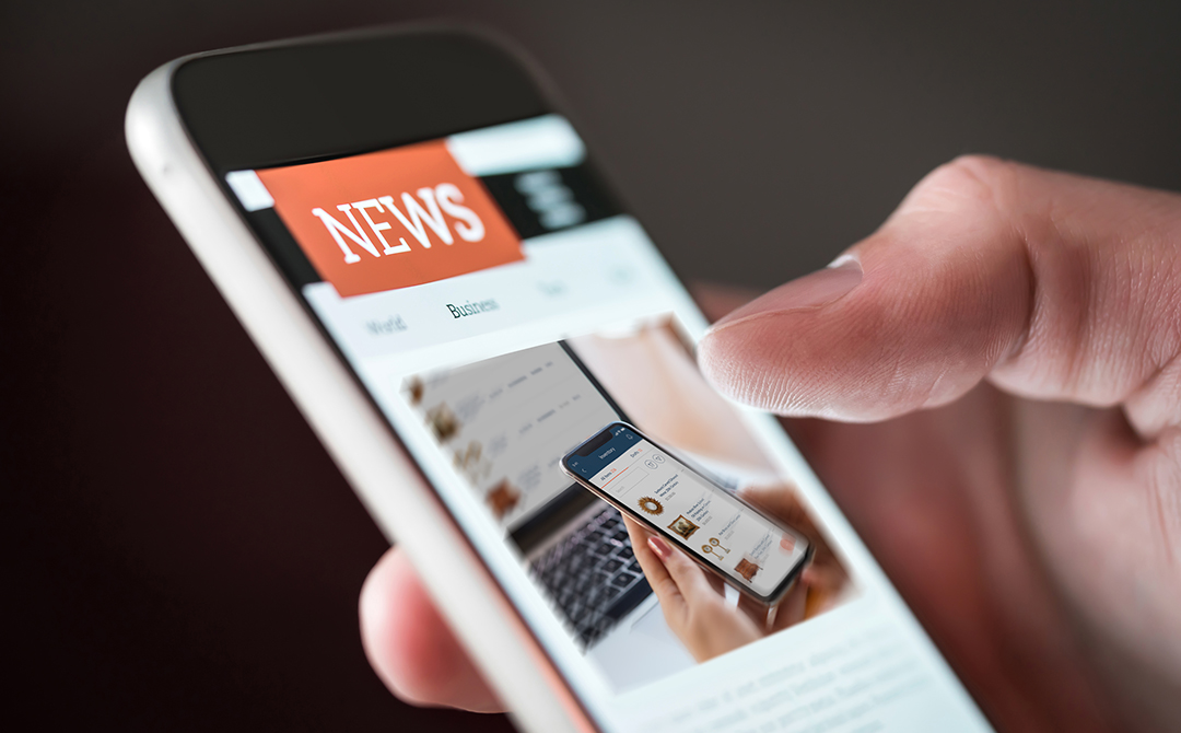 Dealer accessing Ronati Studio news on a smartphone, representing how over 2,000 users are staying updated on the groundbreaking inventory management platform that has processed more than 226,000 vintage and antique items.