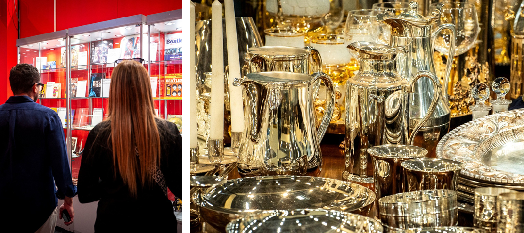 Visitors browsing rare collectibles and silver at Mercanteinfiera, including a Beatles memorabilia display and gleaming antique silverware, showcasing the fair’s eclectic range.