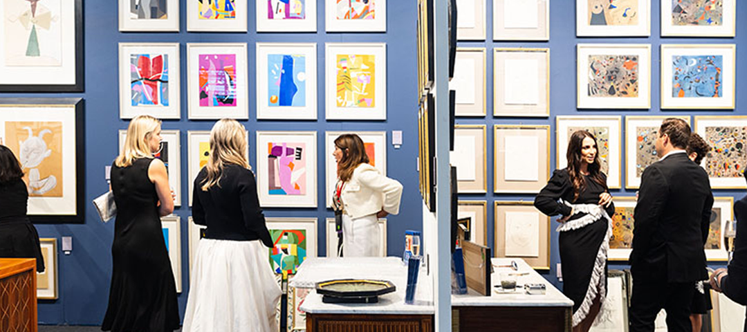 Visitors explore gallery walls lined with framed modern and contemporary works at the San Francisco Fall Show, highlighting the breadth of art on display.