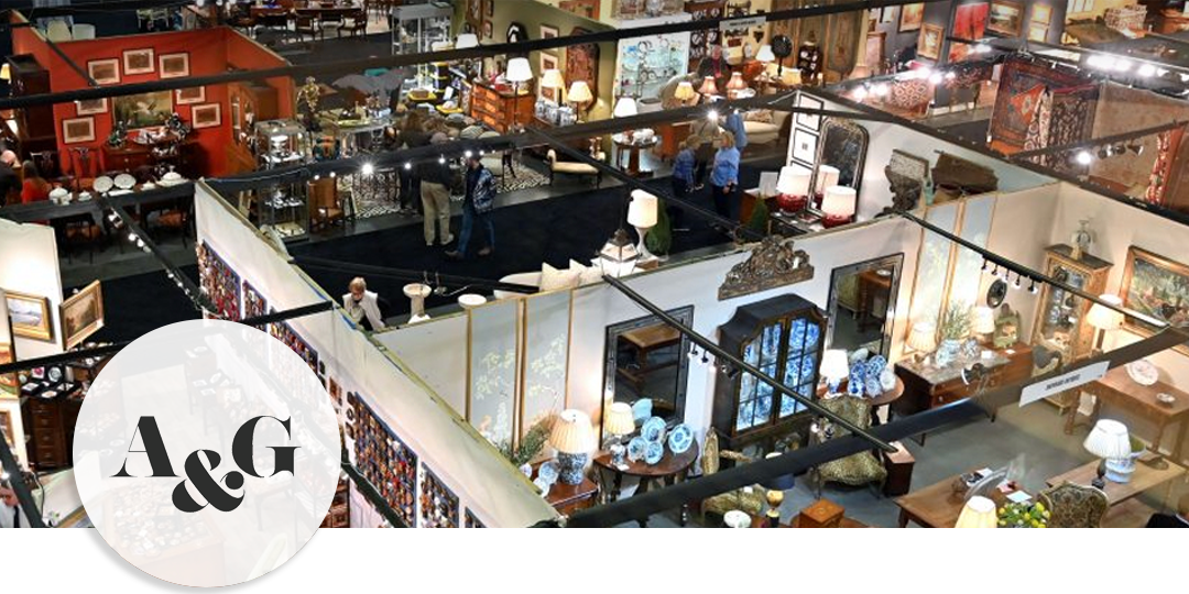 Overhead view of dealer booths at the Nashville Antiques & Garden Show, displaying curated furniture, art, and decorative objects under bright lights.