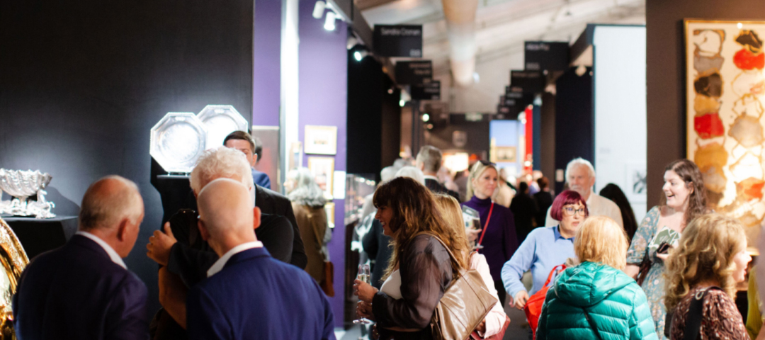 Collectors and dealers mingling in the main pavilion of LAPADA Berkeley Square Fair during the busy autumn event.
